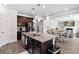 Open kitchen features a granite countertop island with stainless steel appliances and leads into the living room at 109 Logan Pass Dr, Loganville, GA 30052