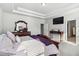 An ornate main bedroom with trey ceiling and a decorative wood bedframe at 109 Logan Pass Dr, Loganville, GA 30052
