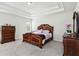 Spacious main bedroom with trey ceilings and elegant wood furnishings at 109 Logan Pass Dr, Loganville, GA 30052