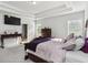 Comfortable main bedroom featuring a trey ceiling and ample light at 109 Logan Pass Dr, Loganville, GA 30052