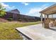 Covered patio with furniture, adjacent to landscaped yard at 109 Logan Pass Dr, Loganville, GA 30052