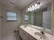 Bathroom with dual sink vanity, large mirror, and ample counter space at 1301 Winesap Se Ct, Conyers, GA 30013