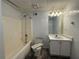 Standard bathroom with a shower-tub combo, single sink vanity, and tile flooring at 1301 Winesap Se Ct, Conyers, GA 30013