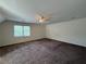 Large bedroom featuring carpet, ceiling fan, and natural light from a window at 1301 Winesap Se Ct, Conyers, GA 30013
