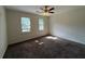 Bedroom featuring carpet, ceiling fan, and natural light from two windows at 1301 Winesap Se Ct, Conyers, GA 30013