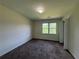 Neutral bedroom with carpet, one window, and white trim at 1301 Winesap Se Ct, Conyers, GA 30013