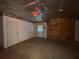 Unfinished garage space with concrete floors, exposed ceiling, and a single window for natural light at 1301 Winesap Se Ct, Conyers, GA 30013