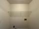 Small storage space with a white wire shelf and neutral walls at 1301 Winesap Se Ct, Conyers, GA 30013