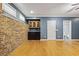 Finished basement with hardwood floors, brick wall, kitchenette and a bathroom at 1605 Pavillion Ridge Se Dr, Smyrna, GA 30080