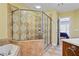 Well-lit bathroom features a glass shower, soaking tub, and a view of the primary bedroom at 1605 Pavillion Ridge Se Dr, Smyrna, GA 30080