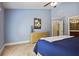 Bright bedroom featuring blue accent wall, light wood dresser, and neutral carpeting at 1605 Pavillion Ridge Se Dr, Smyrna, GA 30080