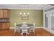 Cozy dining area with hardwood floors, modern lighting, and sliding glass doors to the exterior at 1605 Pavillion Ridge Se Dr, Smyrna, GA 30080