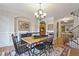 Cozy dining room with chandelier, hardwood floors, and a view of the kitchen and living room at 1605 Pavillion Ridge Se Dr, Smyrna, GA 30080