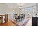 Elegant dining room with hardwood floors, a chandelier, and a bay window overlooking the neighborhood at 1605 Pavillion Ridge Se Dr, Smyrna, GA 30080