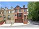 Charming brick townhome with attached two-car garage, steps to front door, and manicured landscaping at 1605 Pavillion Ridge Se Dr, Smyrna, GA 30080