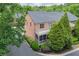 The exterior of a brick townhome boasts a screened porch and small balcony, surrounded by mature trees at 1605 Pavillion Ridge Se Dr, Smyrna, GA 30080