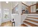 Light-filled foyer with hardwood floors, a staircase with iron railing, and a glass-paneled front door at 1605 Pavillion Ridge Se Dr, Smyrna, GA 30080