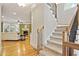 Inviting living room with hardwood floors, a fireplace, and a staircase leading to the second floor at 1605 Pavillion Ridge Se Dr, Smyrna, GA 30080