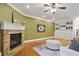 Bright living room featuring hardwood floors, a stone fireplace, and custom built-in bookshelves at 1605 Pavillion Ridge Se Dr, Smyrna, GA 30080