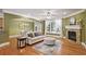 Spacious living room featuring hardwood floors, a fireplace, and large windows allowing natural light at 1605 Pavillion Ridge Se Dr, Smyrna, GA 30080