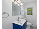 Bathroom with modern vanity, matching toilet, a window, and a mirror at 1640 Fairburn Sw Rd, Atlanta, GA 30331