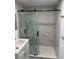Modern bathroom featuring glass shower with sliding doors and gray tile surround at 1640 Fairburn Sw Rd, Atlanta, GA 30331