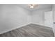 A simple bedroom with neutral tones and hardwood floors, providing a blank canvas for personalization at 1640 Fairburn Sw Rd, Atlanta, GA 30331