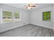 Sunlit bedroom features a ceiling fan and hardwood style floors at 1640 Fairburn Sw Rd, Atlanta, GA 30331