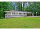 Charming single-story home featuring a blue front door, a brick facade, and a well-manicured lawn at 1640 Fairburn Sw Rd, Atlanta, GA 30331