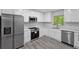 Bright kitchen features stainless steel appliances, white countertops, and sleek white cabinetry at 1640 Fairburn Sw Rd, Atlanta, GA 30331
