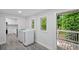 Bright laundry room with modern washer and dryer next to the door to the deck with green vegetation at 1640 Fairburn Sw Rd, Atlanta, GA 30331