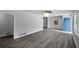 Spacious living room with wood-look flooring and a bright blue front door at 1640 Fairburn Sw Rd, Atlanta, GA 30331