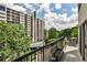 Balcony overlooks lush trees and pool with table and chairs; perfect for outdoor living at 275 13Th Ne St # 605, Atlanta, GA 30309
