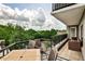 Relaxing condo balcony with furniture and views of the nearby lush treetops at 275 13Th Ne St # 605, Atlanta, GA 30309