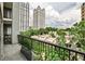 Balcony view of Midtown Atlanta buildings and lush greenery for serene outdoor space at 275 13Th Ne St # 605, Atlanta, GA 30309
