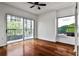 Bright bedroom featuring hardwood floors, fan, and sliding glass doors opening to a balcony with city views at 275 13Th Ne St # 605, Atlanta, GA 30309