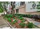 Well-maintained building exterior with manicured landscaping and sidewalk pathway at 275 13Th Ne St # 605, Atlanta, GA 30309