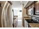 Well-equipped kitchen with stainless steel appliances and granite countertops, with an adjacent living area at 275 13Th Ne St # 605, Atlanta, GA 30309
