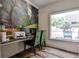 A cozy office space with a desk, comfortable chairs, and a large window overlooking the outdoor area at 275 13Th Ne St # 605, Atlanta, GA 30309