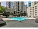 Relaxing outdoor pool area with lounge chairs and city views for premier urban living at 275 13Th Ne St # 605, Atlanta, GA 30309