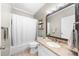 Well-lit bathroom with a shower-tub combo, granite countertops, and a large mirror at 3030 Heatherstone Dr, Cumming, GA 30041