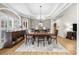 Elegant dining room with a chandelier, large windows, and a tray ceiling, perfect for entertaining at 3030 Heatherstone Dr, Cumming, GA 30041
