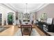 Formal dining room showcasing hardwood floors, arched windows, tray ceiling, and stylish furnishings at 3030 Heatherstone Dr, Cumming, GA 30041
