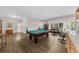 Large game room featuring a pool table, custom bar and views of the backyard at 3030 Heatherstone Dr, Cumming, GA 30041