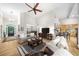 Bright living room features high ceilings, hardwood floors, and an open layout connecting to the kitchen at 3030 Heatherstone Dr, Cumming, GA 30041