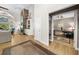 Inviting living room with hardwood floors, stone fireplace, built-in shelving, and an adjacent office space at 3030 Heatherstone Dr, Cumming, GA 30041