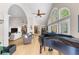Elegant living space with a grand piano, vaulted ceilings, arched windows, and hardwood floors at 3030 Heatherstone Dr, Cumming, GA 30041