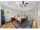 Tranquil main bedroom features a tray ceiling, hardwood floors, balcony access, and natural light at 3030 Heatherstone Dr, Cumming, GA 30041
