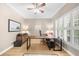 Office with plantation shutters, hardwood floors, and a custom desk overlooking the property at 3030 Heatherstone Dr, Cumming, GA 30041