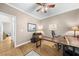 Office space with a ceiling fan, hardwood floors, and a custom desk with views of the property at 3030 Heatherstone Dr, Cumming, GA 30041